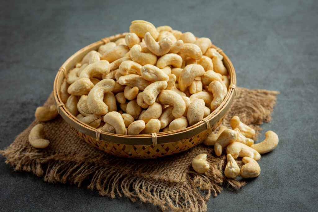 Home raw cashews nuts in bowl on dark background
